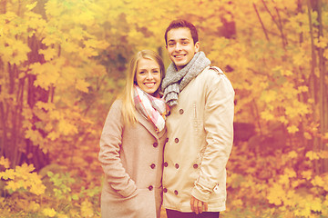 Image showing smiling couple hugging in autumn park