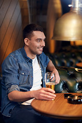 Image showing happy man drinking draft beer at bar or pub