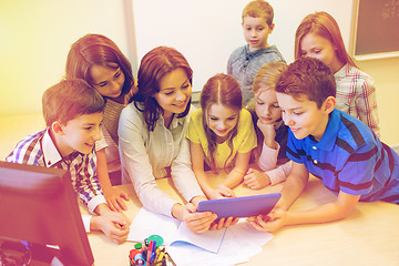 Image showing group of kids with teacher and tablet pc at school