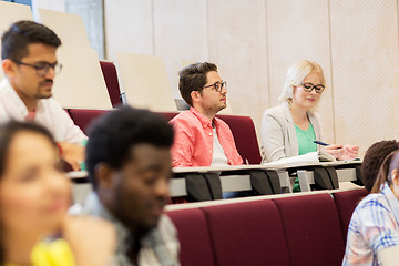Image showing group of students with notebooks in lecture hall