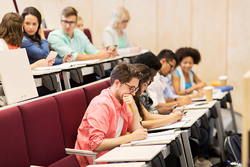 Image showing group of students with notebooks in lecture hall