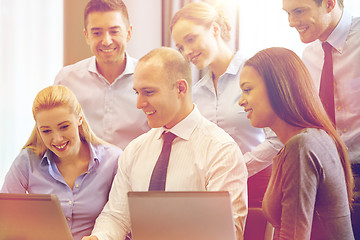 Image showing smiling business people with laptop computer