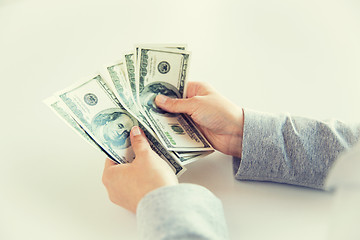 Image showing close up of woman hands counting us dollar money