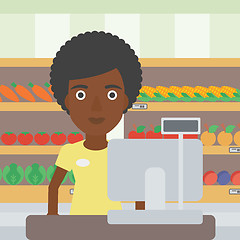 Image showing Cashier standing at the checkout in supermarket.