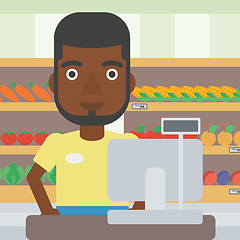 Image showing Cashier standing at the checkout in supermarket.