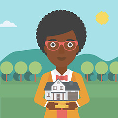 Image showing Woman holding house model vector illustration.