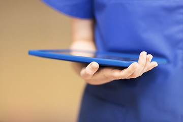 Image showing close up of female doctor or nurse with tablet pc