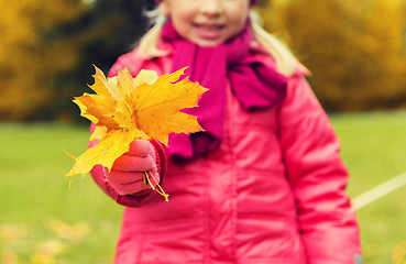 Image showing close up of happy girl with autumnn maple leaves