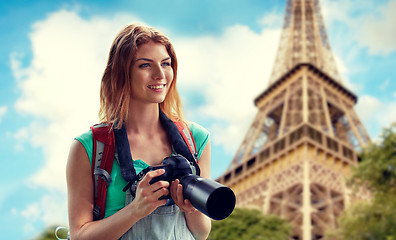 Image showing woman with backpack and camera over eiffel tower