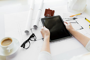 Image showing close up of hand with blueprint and tablet pc