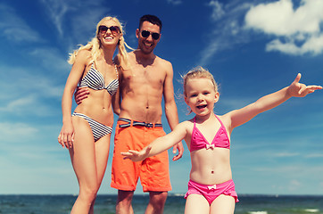 Image showing close up of happy family with child on beach