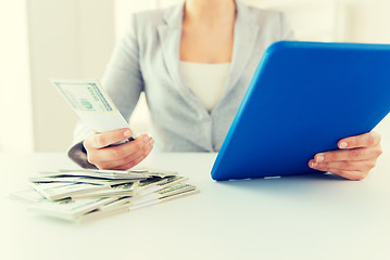 Image showing close up of woman hands with tablet pc and money