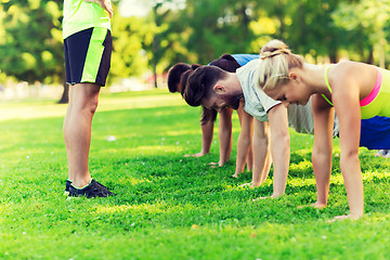 Image showing group of friends or sportsmen exercising outdoors