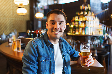 Image showing happy man drinking beer at bar or pub