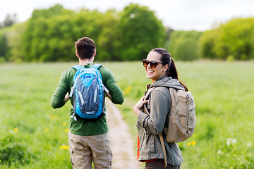 Image showing happy couple with backpacks hiking outdoors