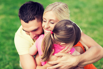 Image showing happy family hugging outdoors