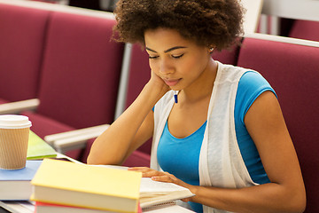 Image showing student girl with books and coffee on lecture