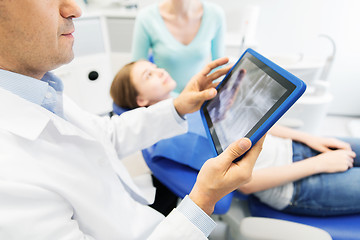 Image showing dentist with x-ray on tablet pc with patient girl