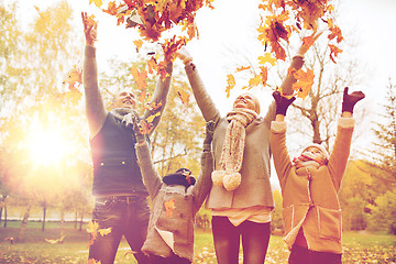 Image showing happy family playing with autumn leaves in park