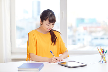 Image showing happy asian woman student with tablet pc at home