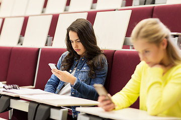 Image showing student girls with smartphones on lecture