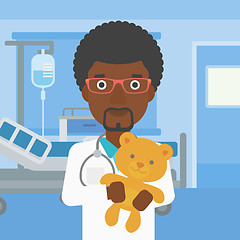 Image showing Pediatrician doctor holding teddy bear.