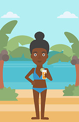 Image showing Woman with cocktail on the beach.