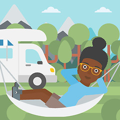 Image showing Woman lying in hammock in front of motor home.