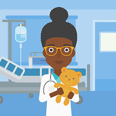 Image showing Pediatrician doctor holding teddy bear.