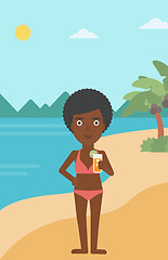 Image showing Woman with cocktail on the beach.