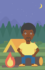 Image showing Man sitting on log in the camping.