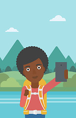 Image showing Woman with backpack making selfie.