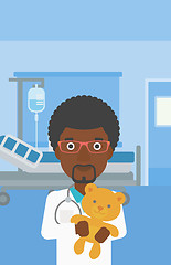 Image showing Pediatrician doctor holding teddy bear.