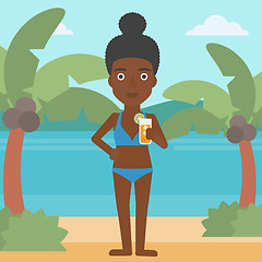 Image showing Woman with cocktail on the beach.