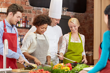 Image showing happy friends and chef cook cooking in kitchen