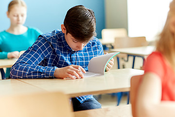 Image showing group of students with books writing school test