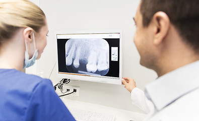 Image showing close up of dentist and assistant at dental clinic