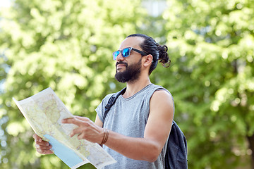 Image showing man traveling with backpack and map in city