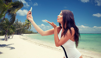 Image showing young woman taking selfie with smartphone