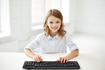 Image showing smiling girl with keyboard at school