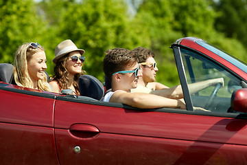 Image showing happy friends driving in cabriolet car