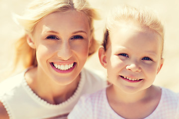 Image showing happy mother and little daughter on summer beach