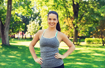 Image showing happy young woman exercising outdoors