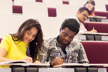 Image showing group of students with notebooks in lecture hall