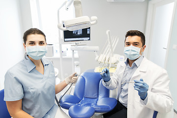 Image showing close up of dentist and assistant at dental clinic