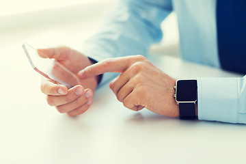 Image showing close up of hands with smart phone and watch