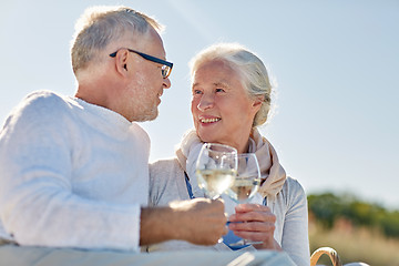 Image showing happy senior couple having picnic on summer beach