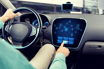 Image showing close up of man driving car with on board computer