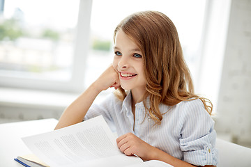 Image showing happy student girl reading book at school