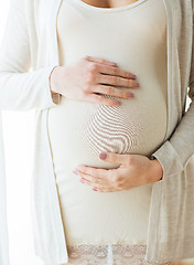 Image showing close up of pregnant woman belly and hands